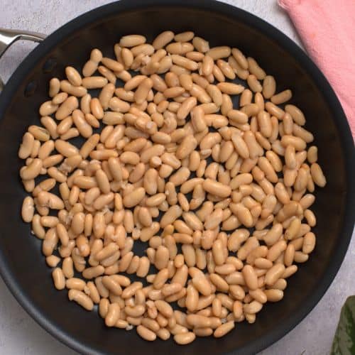 Cooking beans in a frying pan.