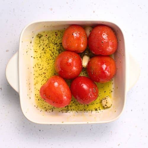 Cooked tomatoes in a ceramic pan.