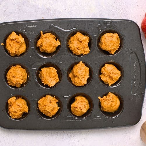 Pumpkin Donut Holes batter in a muffin pan.