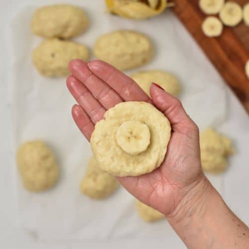 Placing a slice of banana on the Banana Beignets dough