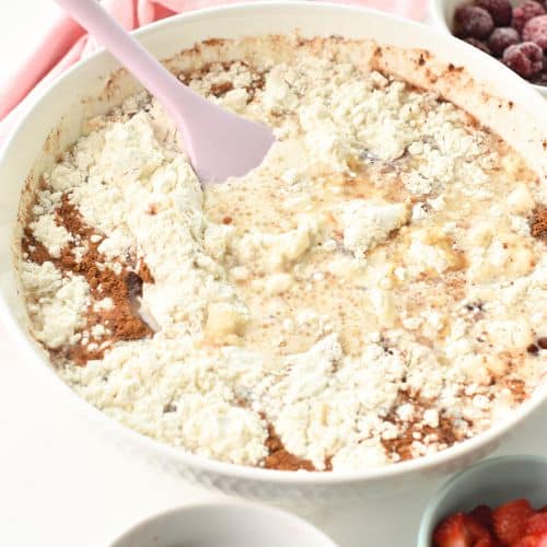 Adding the flour to the batter.