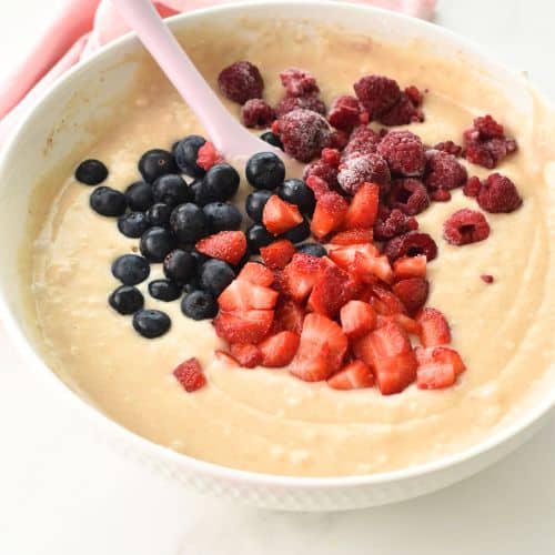 Adding the berries to the batter.