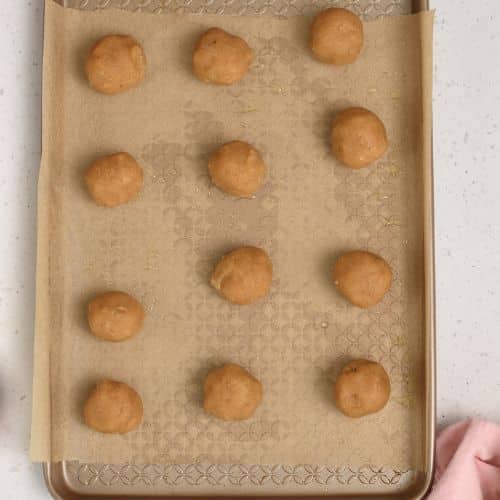 Peanut Butter Banana Cookie dough balls on a baking sheet.
