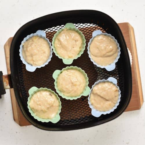Air Fryer Banana Muffins ready to bake in the air fryer basket.