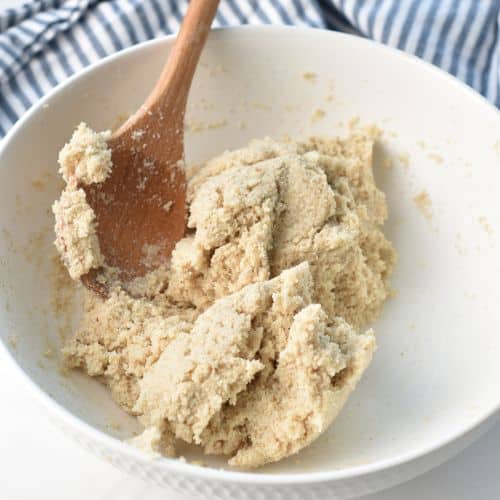 Stirring the Almond Flour Bread batter in a bowl.