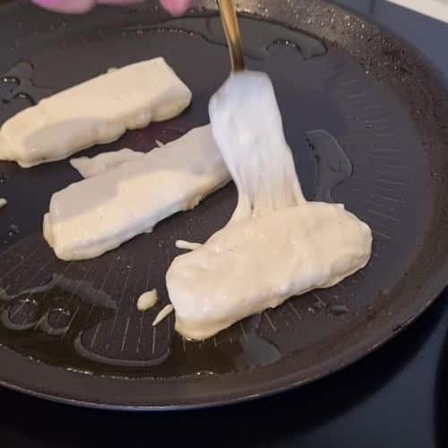 Cooking Banana Fritters on a pan.