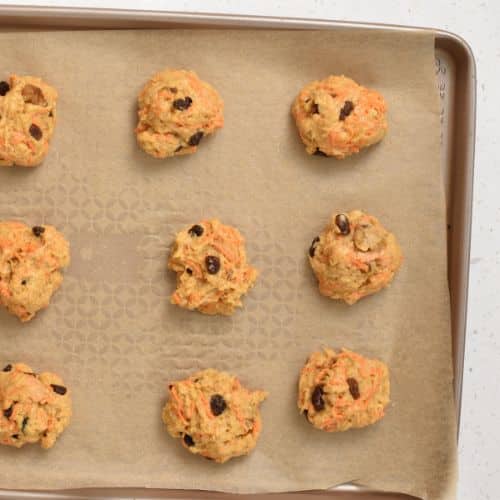 Carrot Cake Cookie dough balls on a baking sheet.