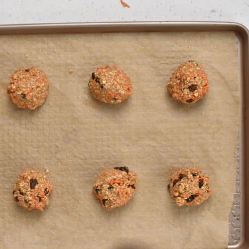 Carrot Oatmeal Cookie dough balls on a baking sheet.