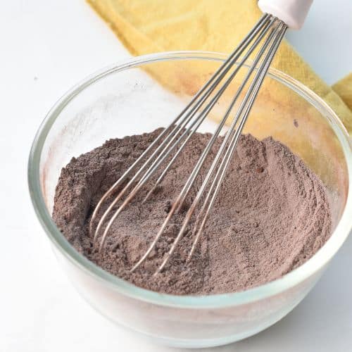 Mixing dry Chocolate Banana Bread ingredients in a bowl.
