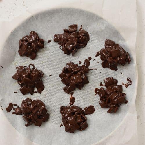 Chocolate Cereal Clusters on a plate ready to set.