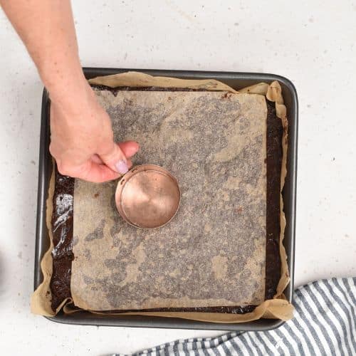 Pressing the Date Brownie batter in a pan.