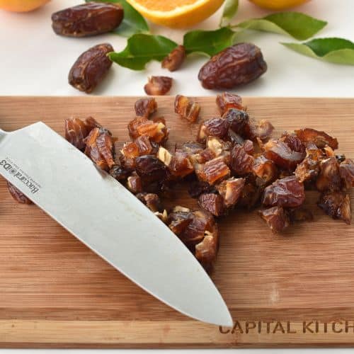Slicing dates on a chopping board.