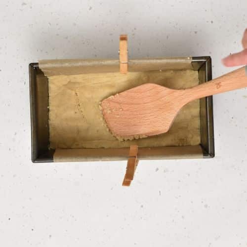Pressing the Healthy Snicker base in the pan.
