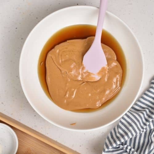 Mixing maple syrup and peanut butter.