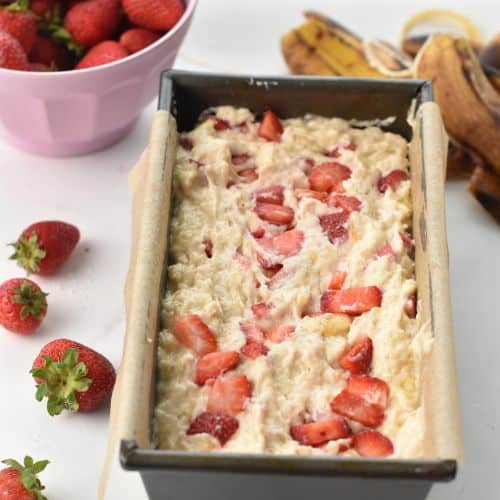 Strawberry Banana Bread ready to bake in a pan.