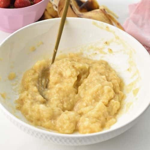Mash the bananas in a mixing bowl.