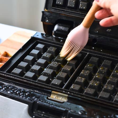 Oiling a waffle iron.