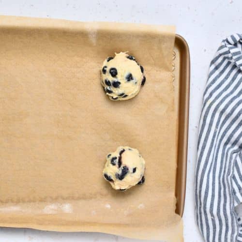 Blueberry Muffin Cookie dough balls on a baking sheet.