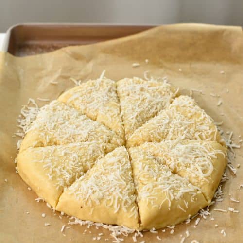 Coconut Scone dough disc cut into 8 portions.
