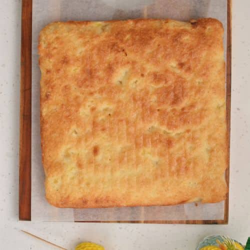 Pineapple Coconut Cake baked on a wooden board.