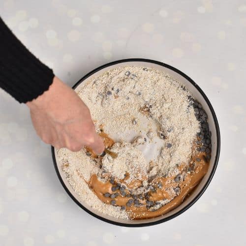 Adding oat flour to the Cookie Dough Cup batter.