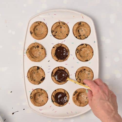Adding chocolate on the Cookie Dough Cups