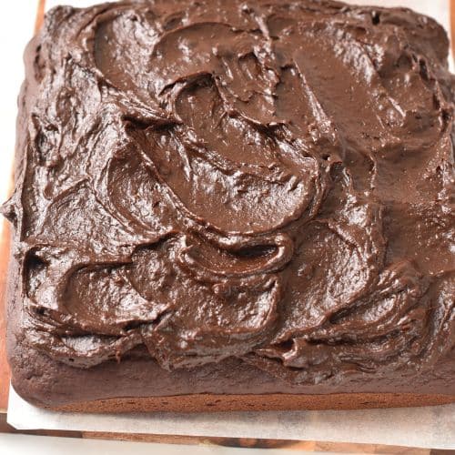 Spreading date frosting on the cake.
