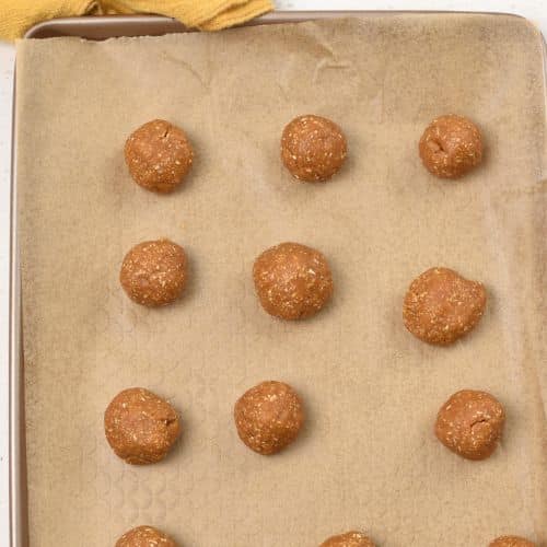 Oat Flour Peanut Butter Cookie dough balls on a baking sheet.