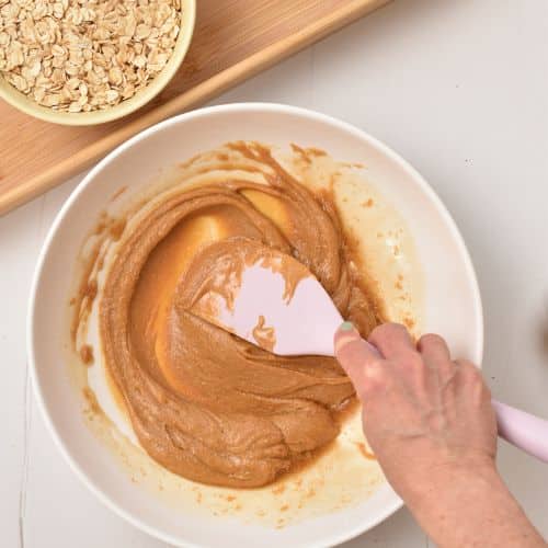 Mixing the peanut butter and maple syrup.