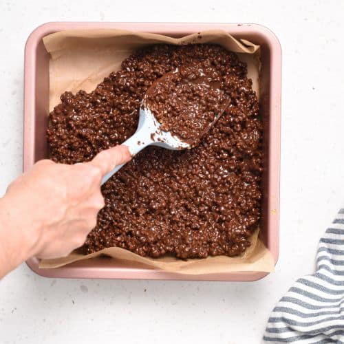 Spreading the Protein Crisp Bar batter in a square pan.