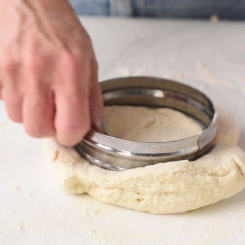 Forming scones by pressing a scone cutter on the Protein Scone dough.