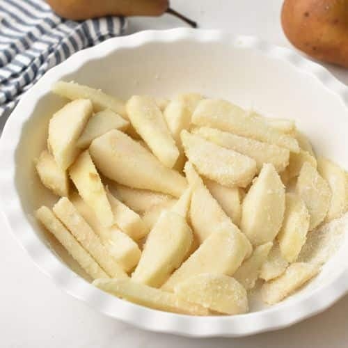 Coated pear slices in a bowl.