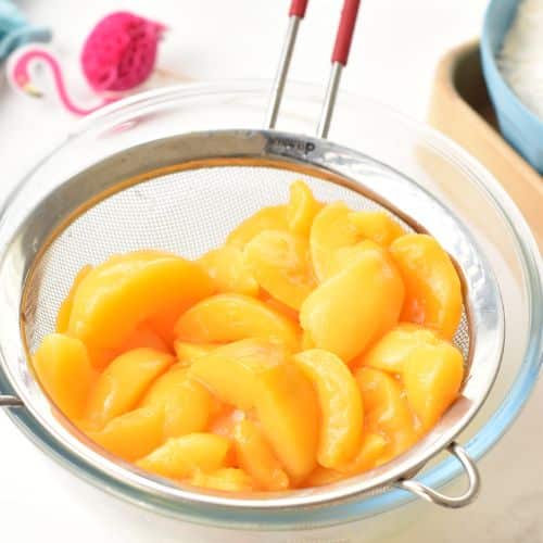 Draining peaches for the Peach Coffee Cake.