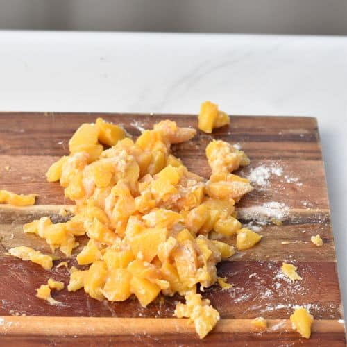 Coating peaches in flour.