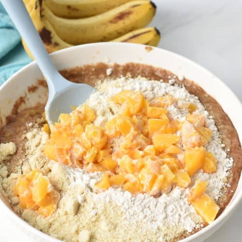 Adding flour and peaches to the Almond Flour Peach Banana Bread batter