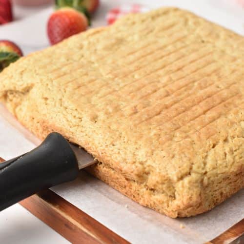Slicing the cooked cake into two layers.