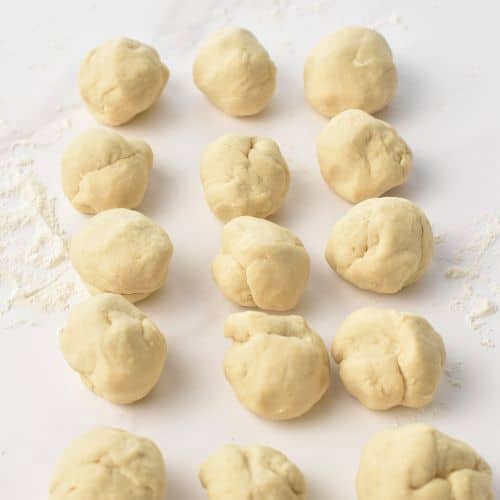 Splitting the dough into small balls.